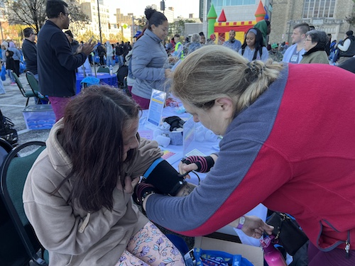 GMercyU Nursing student provides blood pressure screening to patient