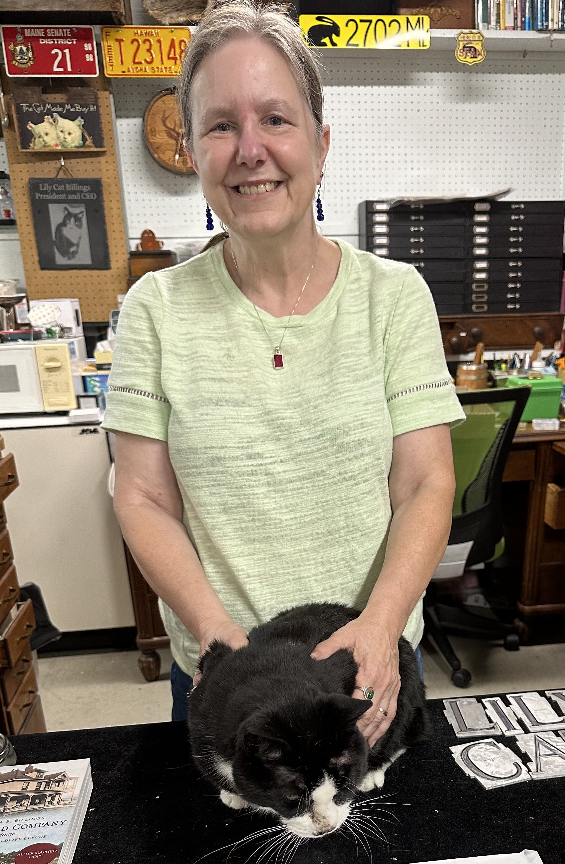 Johanna Billings in her antique shop with cat lily