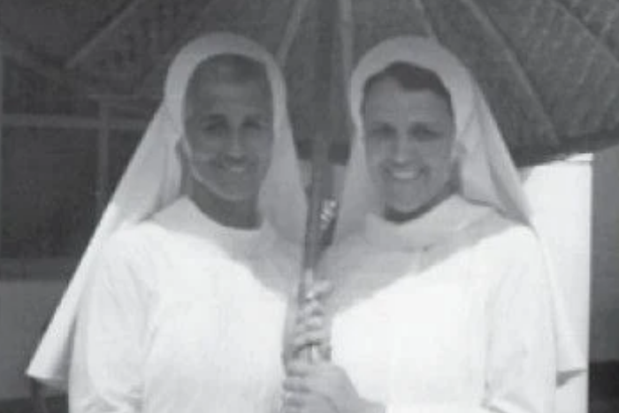 Sister Thomasina Kavanagh, RSM, (left) and Sister Mary Klock, RSM share a bamboo umbrella. 